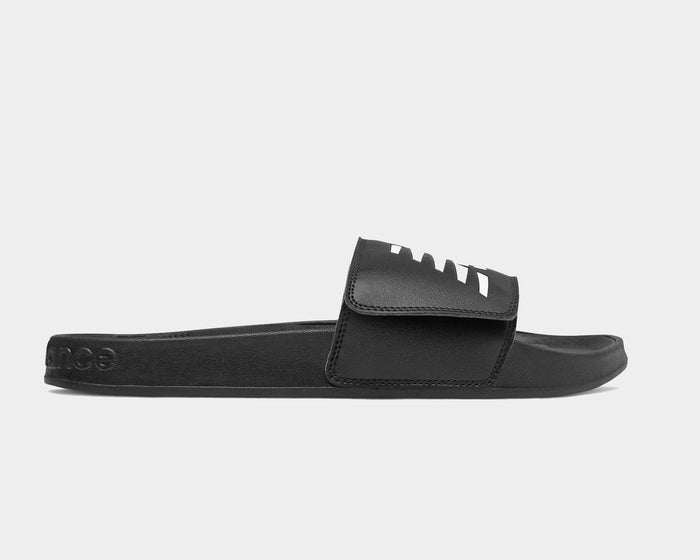 New Balance 200 Adjustable slides in black with white logo detailing, adjustable strap, and synthetic sole, side view.