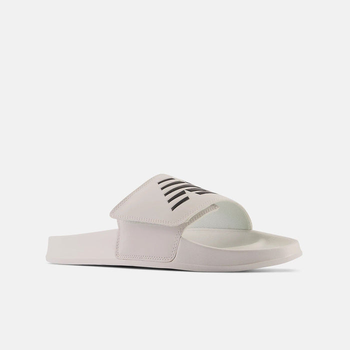 New Balance 200v2 Adjustable slides in white with black logo detailing, cushioned footbed and adjustable strap, side view.