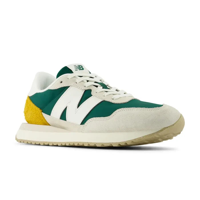 New Balance 237 V1 sneakers in green, white, and yellow with suede overlays, mesh upper, and retro design, angled front view.