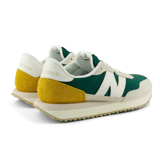 New Balance 237 V1 sneakers in green, white, and yellow suede with retro design, back angle showing heel detail.