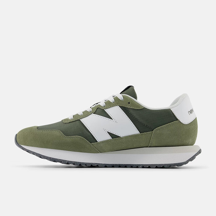 New Balance 237 sneakers in green and white with suede overlays, mesh upper, and signature "N" logo, side view.