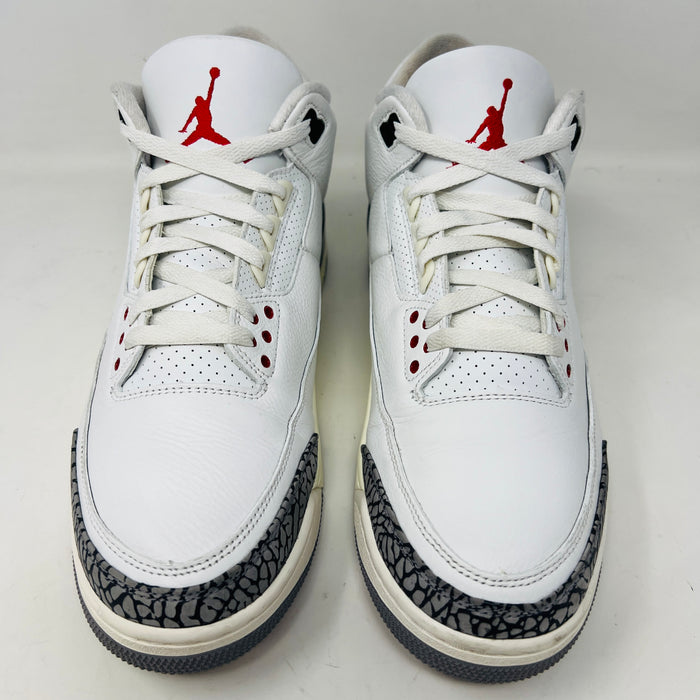 Jordan 3 Retro White Cement sneakers on Nike box, 2023 edition.