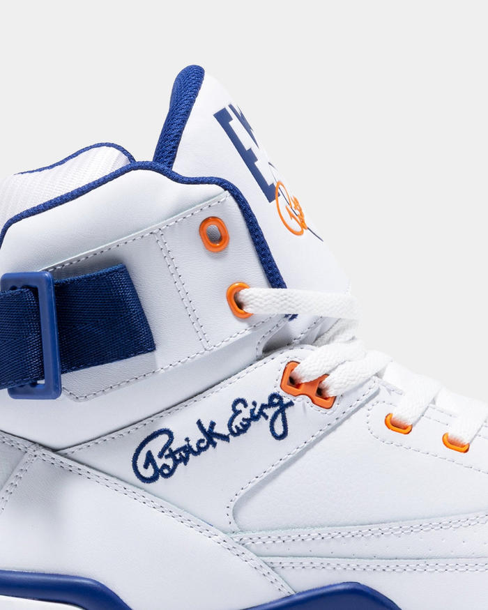 Ewing Athletics 33 HI OG sneakers in white leather with blue and orange accents, showing side details with embroidered signature and strap.
