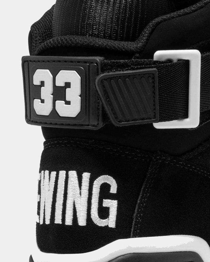 Ewing Athletics 33 HI OG sneakers in black suede with embroidered Ewing branding and adjustable heel strap, close-up back view.