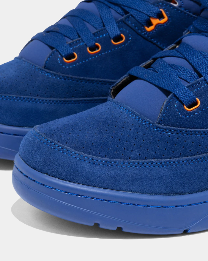 Ewing Athletics 33 HI OG sneakers in royal blue suede with orange eyelets and perforated toe box, close-up view.