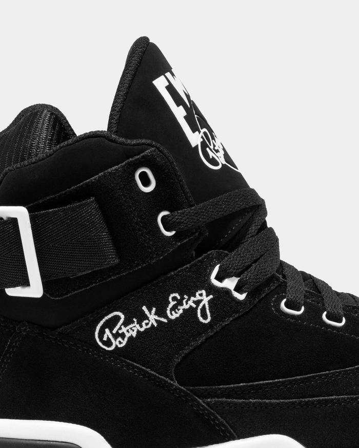 Ewing Athletics 33 HI OG sneakers in black suede with embroidered Patrick Ewing signature, showing close-up side view of upper.