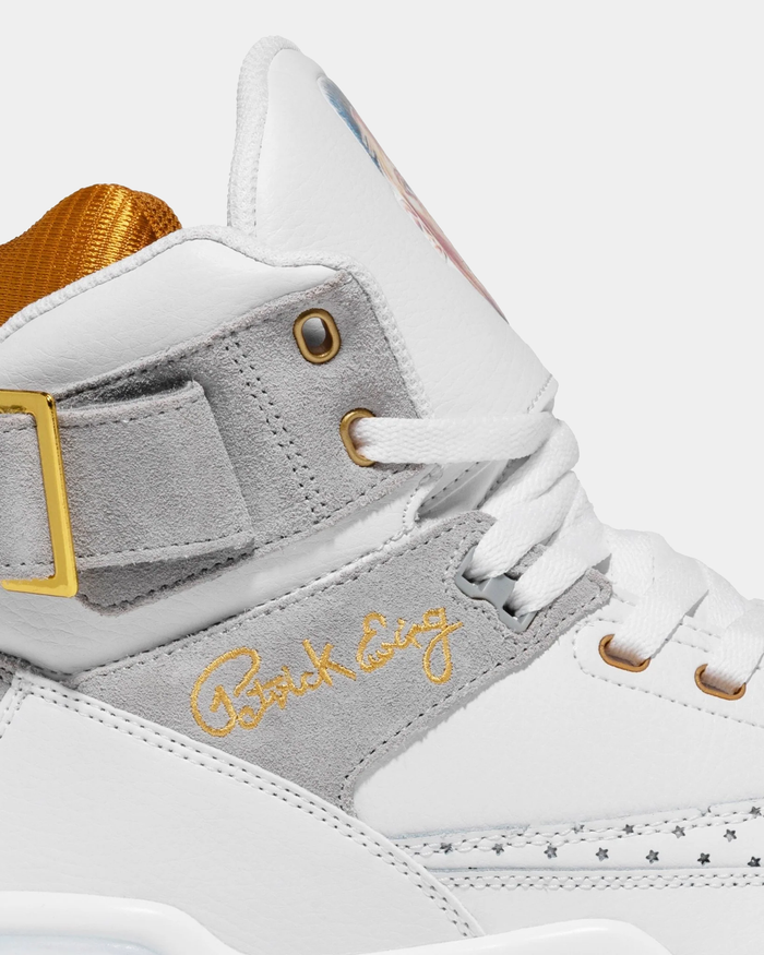 Ewing Athletics 33 HI x LAURENS J sneakers in white leather and gray suede with gold accents and branding, side profile close-up.