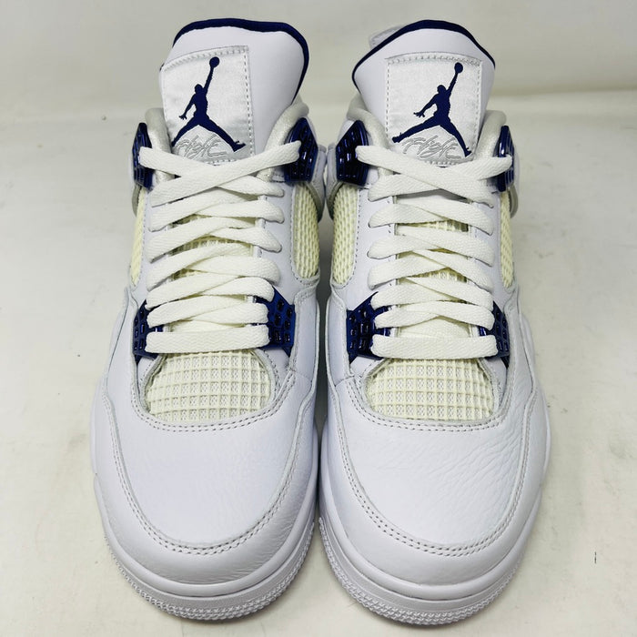 The Jordan 4 Retro Metallic Purple sneaker features white material with blue mesh accents, a visible air cushion in the heel, textured sole, angular overlays, and a padded collar. Note: no box included.
