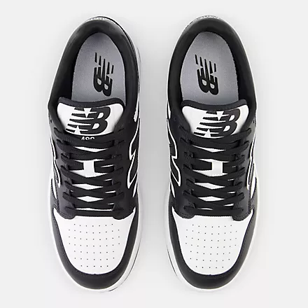New Balance 480 sneakers top view in black and white with perforated toe box and NB branding on the tongue.