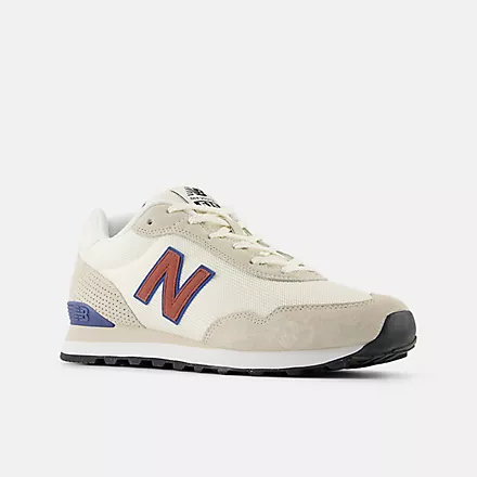 New Balance 515 v3 sneakers in beige with red and blue logo, side view showing mesh upper and rubber sole.