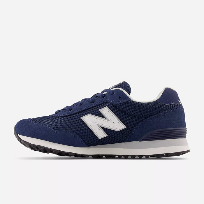 New Balance 515 v3 sneakers in navy blue with white logo, suede and mesh upper, cushioned midsole, and rubber outsole, side view.
