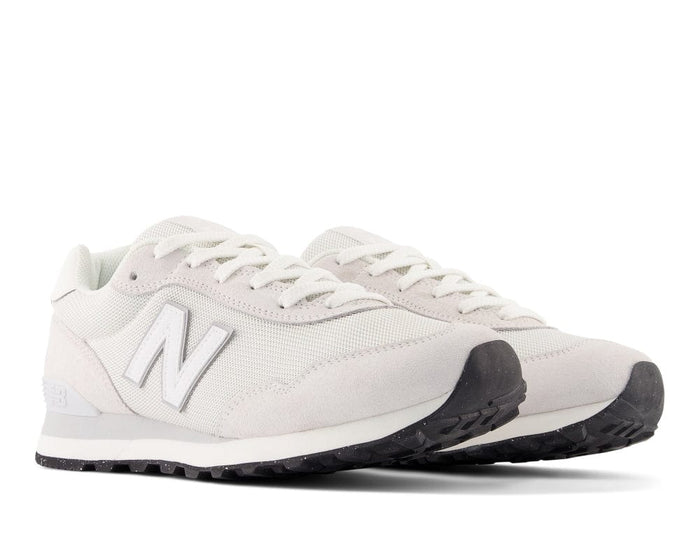 New Balance 515 v3 sneakers in white with mesh upper, suede overlay, and rubber outsole, angled front view.