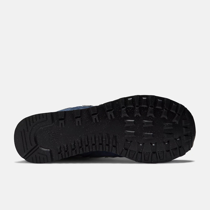 New Balance 574 Core shoes outsole showing durable black rubber tread pattern and flex grooves, bottom view.