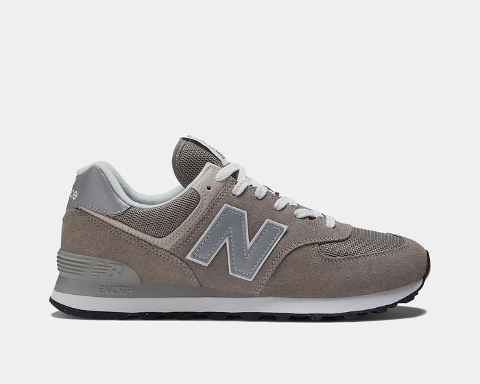 New Balance 574 Core sneakers in gray with suede overlays, breathable mesh panels, white laces, and durable ENCAP midsole, side view.