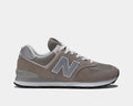 New Balance 574 Core sneakers in gray with suede overlays, breathable mesh panels, white laces, and durable ENCAP midsole, side view.