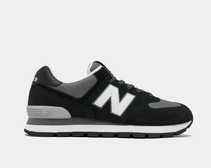 New Balance 574 Rugged shoes in black and gray with suede overlays, mesh panels, ENCAP midsole, and rugged outsole, side view.