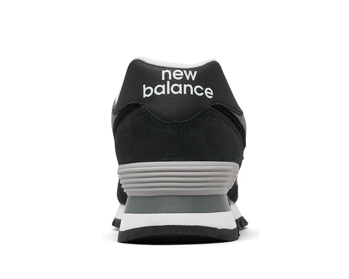 New Balance 574 Rugged sneakers back view showing heel design, black suede upper with gray and white accents