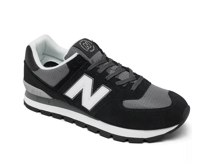 New Balance 574 Rugged sneakers in black and gray with suede overlays, ripstop panels, and ENCAP midsole cushioning, side view.