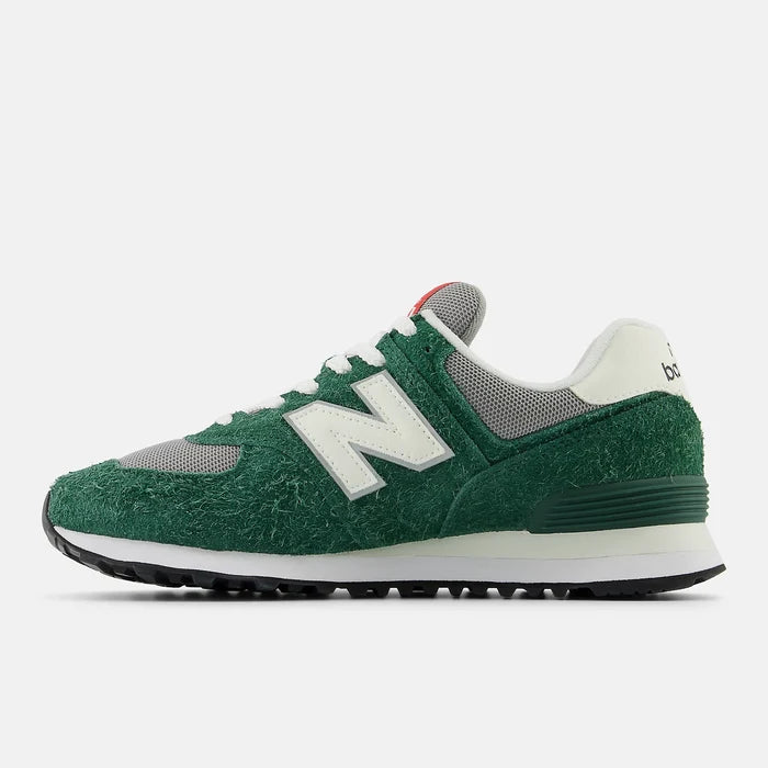 New Balance 574 sneakers in green and gray with textured suede upper, white "N" logo, and black rubber outsole, side view.