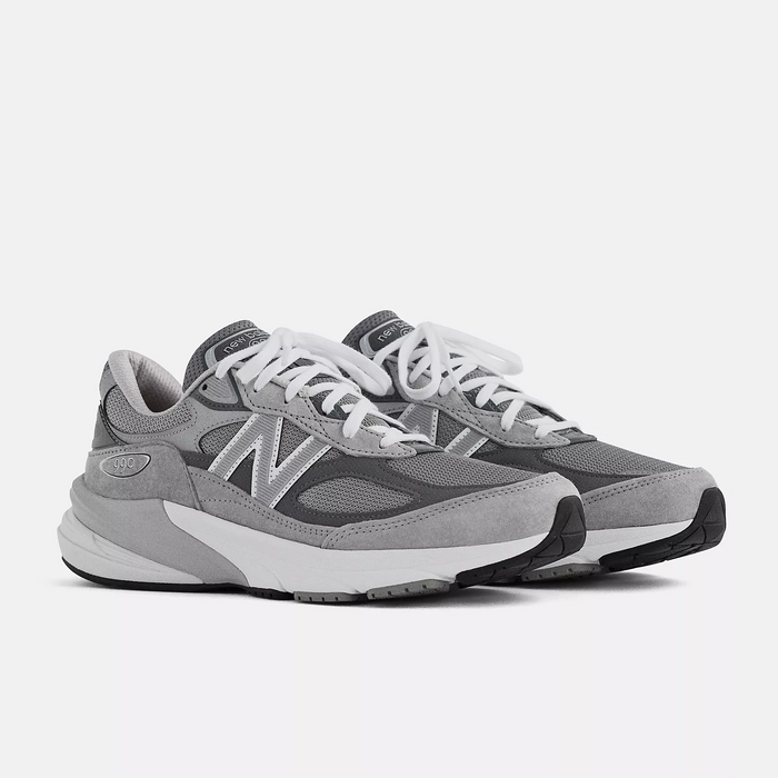 New Balance 990v6 running shoes in gray with suede overlays, mesh panels, and white laces, angled front side view.