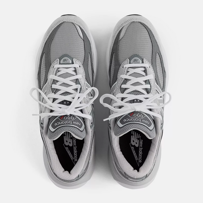 New Balance 990v6 sneakers in gray with mesh upper, white laces, and branded tongue and insole, top view.