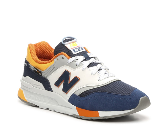 New Balance 997H sneakers in navy, white, and orange with mesh upper, suede overlays, and EVA midsole, angled front view.