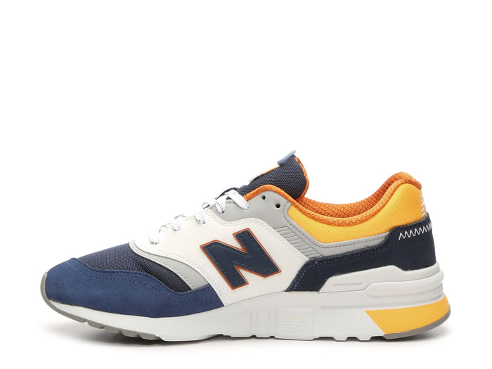 New Balance 997H sneakers in navy blue, white, and yellow with suede and mesh upper, side view showing iconic 'N' logo.