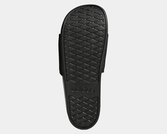 Adidas Adilette Comfort Slides outsole in black showing textured grip pattern and embossed logo.
