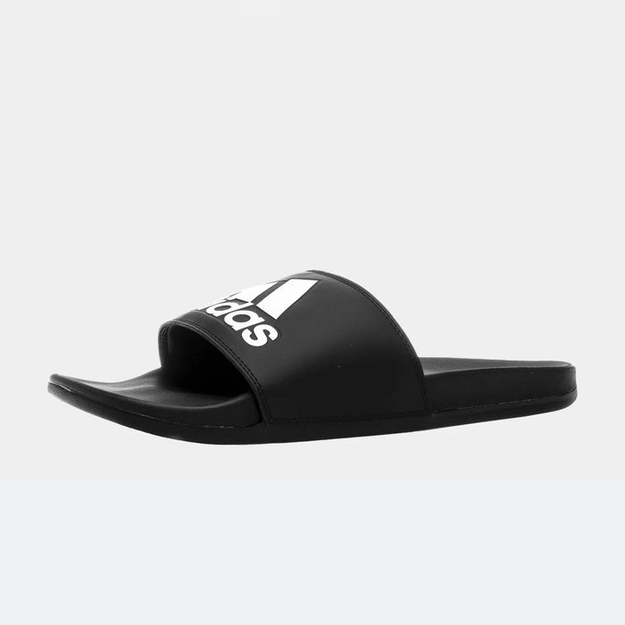 Adidas Adilette Comfort slides in black with white Adidas logo on wide strap, side angle showing cushioned footbed and slip-on design.