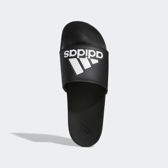 Adidas Adilette Comfort slide sandals in black with white logo branding, top view showing cushioned footbed and single strap.