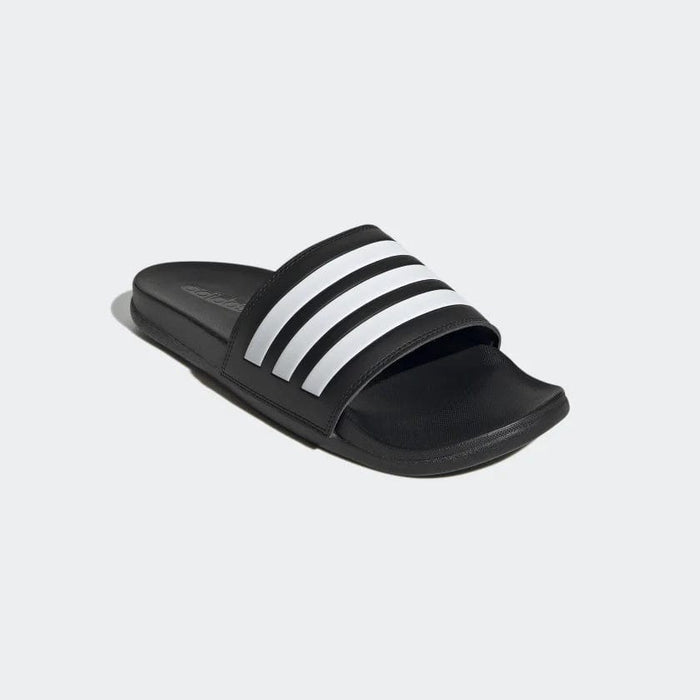 Adidas Adilette Comfort sandals in black with white signature three-stripe design, angled front view.