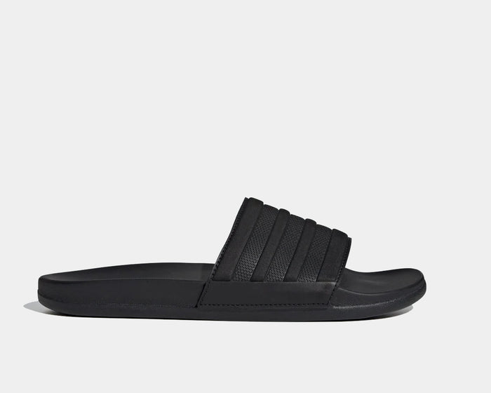 Adidas Adilette Comfort slides in sleek black with textured strap and cushioned sole, side view.