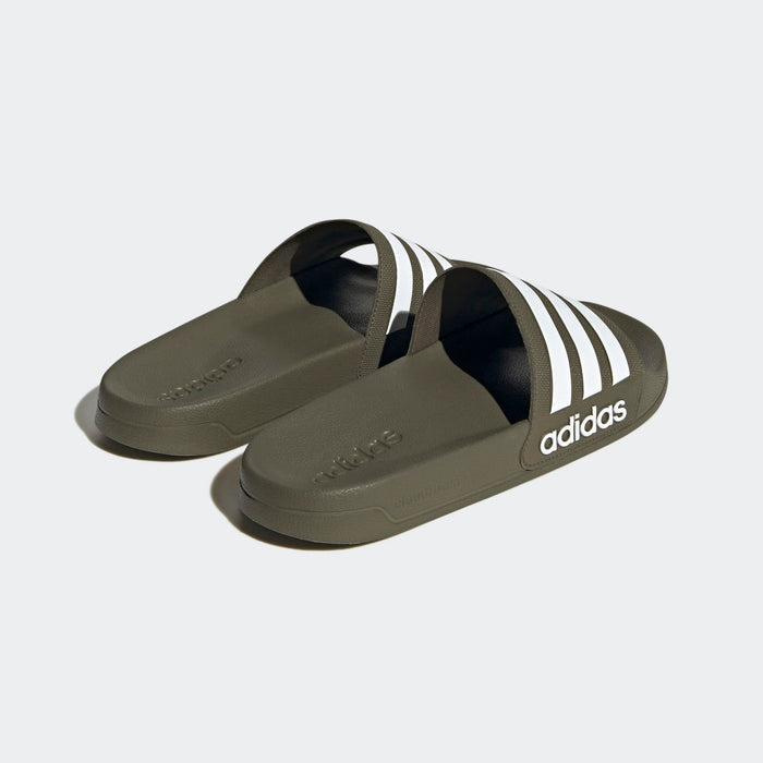 Adidas Adilette Comfort slides in olive green with white stripe accents and embossed branding, angled back view.