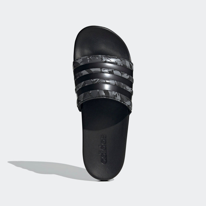 Adidas Adilette Comfort sandals in black with camo-patterned straps, contoured footbed, and Adidas logo, top view.