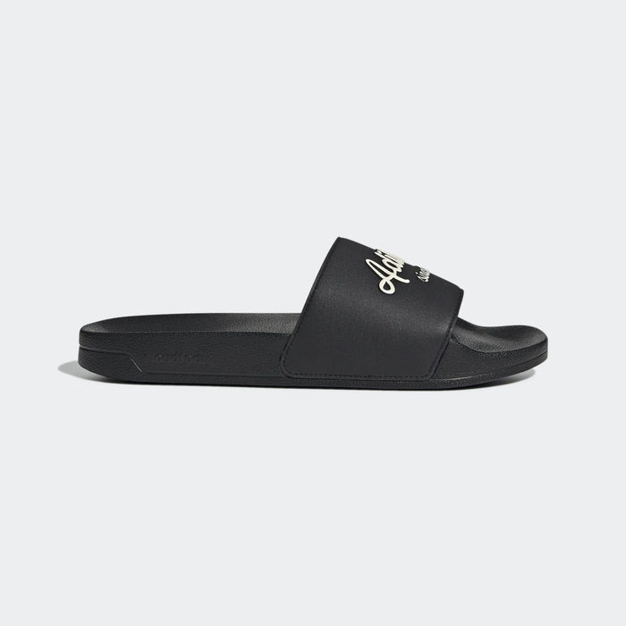 Adidas Adilette Shower Slides in black with white logo and Cloudfoam footbed, side view.
