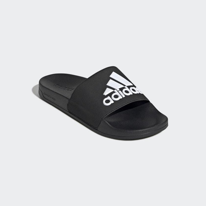 Adidas Adilette Shower Slides in black with bold white logo on wide strap, featuring a contoured footbed, angled front view.