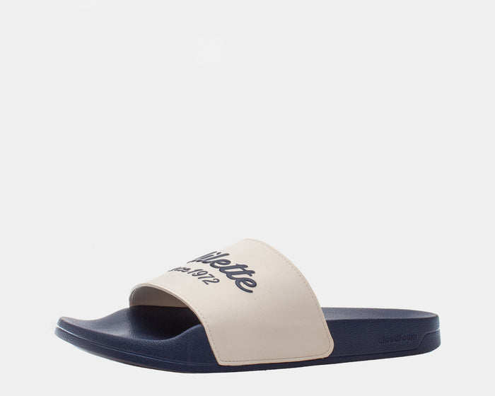 Adidas Adilette Shower Slides in beige and navy blue with a textured footbed and bold logo on strap, side view