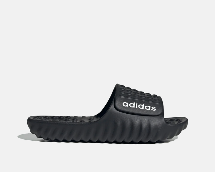 Adidas Adissage 360REC slides in black with textured footbed, contoured sole, and embossed strap featuring Adidas logo, side view.