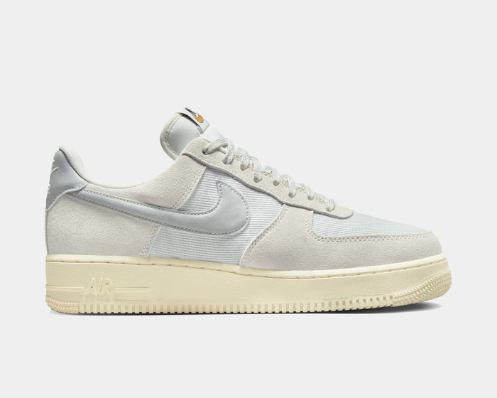 Nike Air Force 1 '07 LV8 sneakers in light gray suede and tonal canvas with signature Swoosh logo, side view.