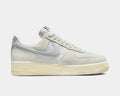 Nike Air Force 1 '07 LV8 sneakers in light gray suede and tonal canvas with signature Swoosh logo, side view.