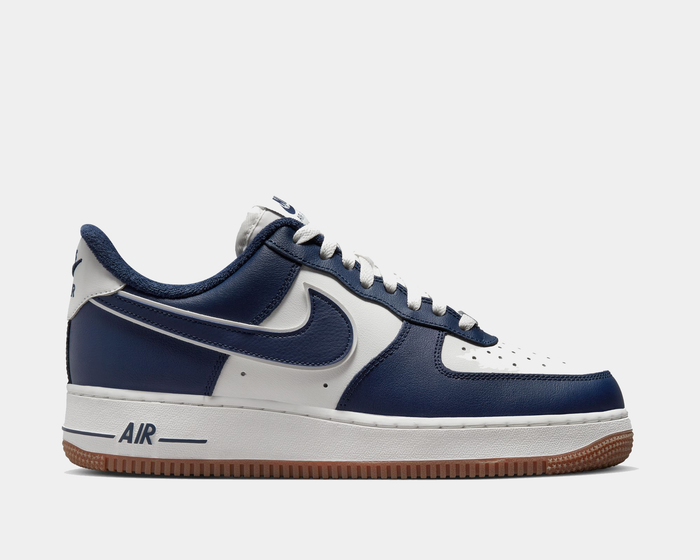Nike Air Force 1 '07 LV8 sneakers in white and navy blue with perforated leather upper, gum outsole, and iconic side swoosh, side view.