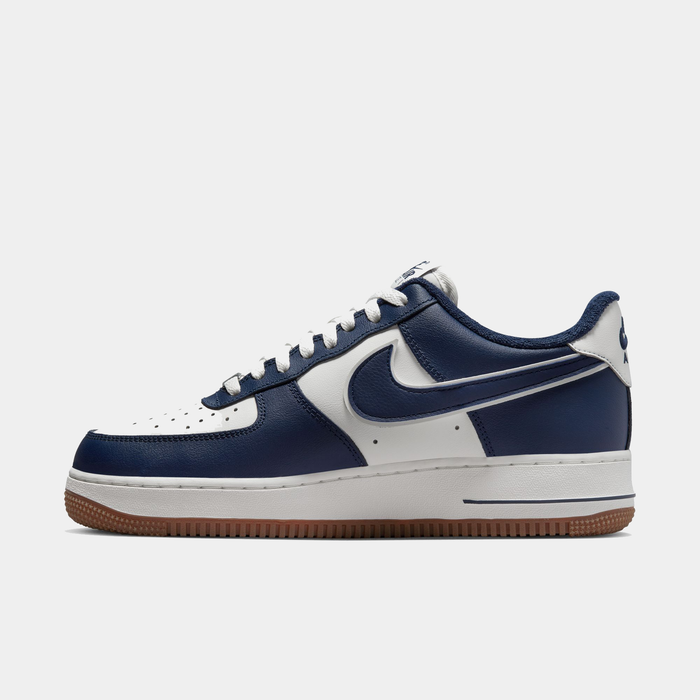Nike Air Force 1 '07 LV8 sneakers in navy blue and white with leather upper, perforated toe box, and gum outsole, side view.
