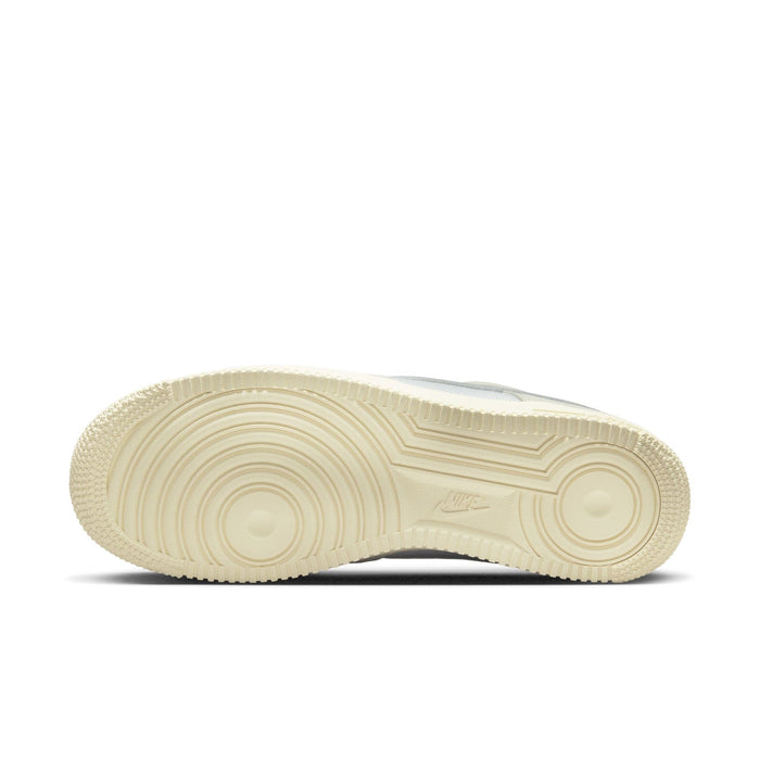 Nike Air Force 1 '07 LV8 outsole in beige, featuring circular tread design and Nike logo, bottom view.