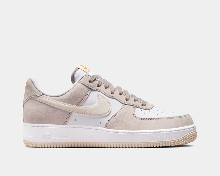 Nike Air Force 1 '07 sneakers in white and beige with suede overlays, perforated toe box, and rubber sole, side view.