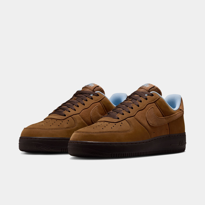 Nike Air Force 1 '07 sneakers in brown suede with perforated toe box, tonal Swoosh logo, and black sole, front angle view