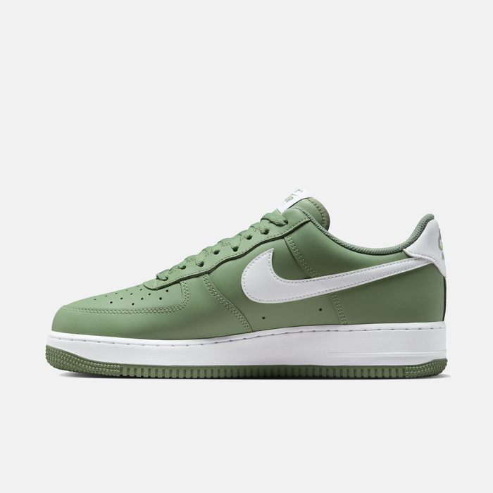 Nike Air Force 1 '07 sneakers in green with a white swoosh logo, perforated toe box, and white midsole, side view.
