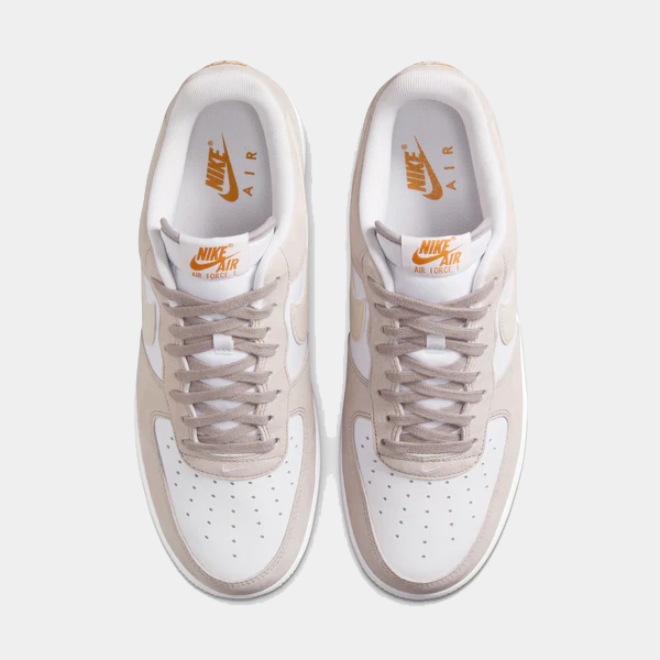 Nike Air Force 1 '07 sneakers in white and beige with perforated toe box, leather upper, and lace system, top view.