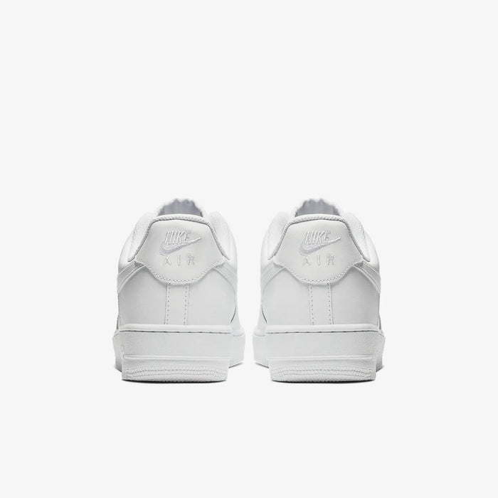 Nike Air Force 1 '07 sneakers in white leather with embossed Nike Air logo and padded heel counter, back view.