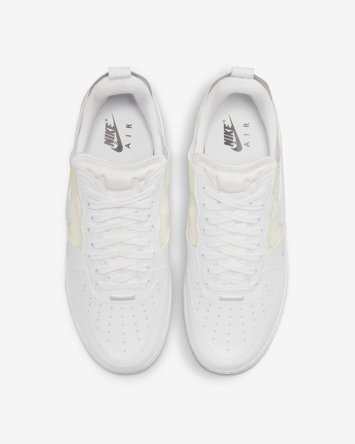 Nike Air Force 1 React sneakers in white with perforated toe box, React foam midsole, and lace-up design, top view.