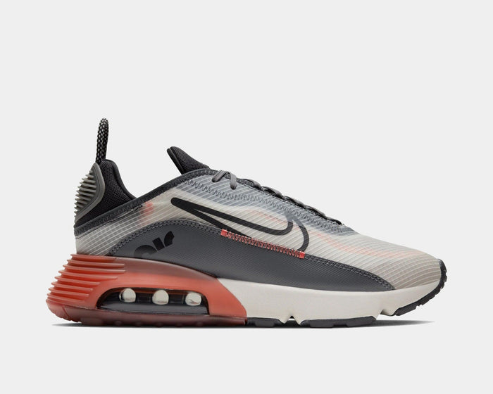 Nike Air Max 2090 sneakers in gray with translucent upper, bold black Swoosh logo, and orange Air unit, side view.